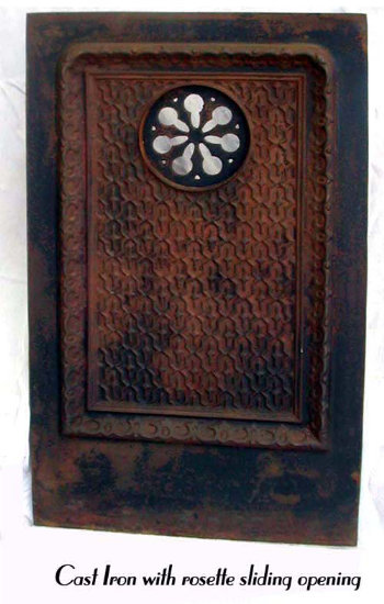 Cast iron architectural element with rosette swinging door.