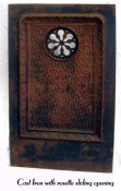 Cast iron architectural element with rosette swinging door.